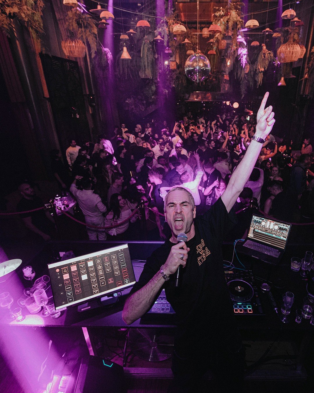 DJ performing to a full dance floor